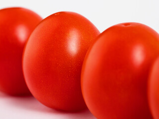 ripe vegetables, oval-shaped red tomatoes on a white background, isolate