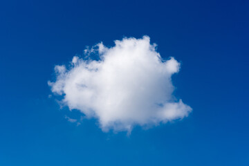 Single white cloud on blue sky background at daytime