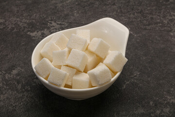 Refined white sugar cubs in the bowl
