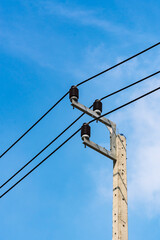 Electricity distribution post with blue sky background