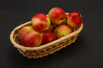 Sweet small nectarines in the basket