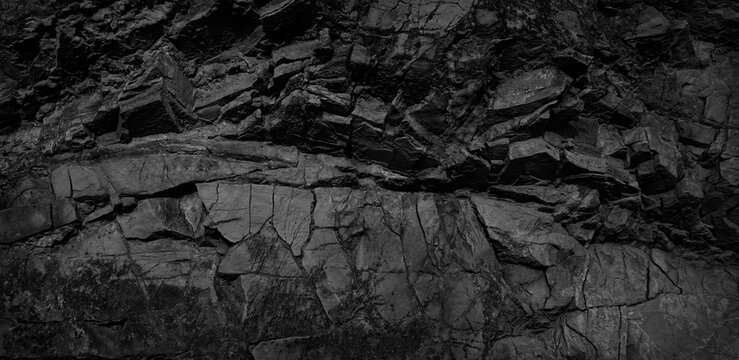 Black and white background. Volumetric black stone background. 3d effect. Rock texture. Granite mountain texture. Close-up.
