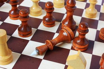 Chess king lays on a chessboard