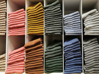 Rows of colorful socks on shelves in supper store or retail store. Stack of socks. Selected focus.