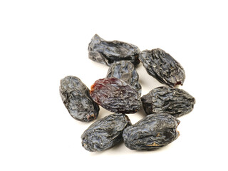 Black raisins on a white background