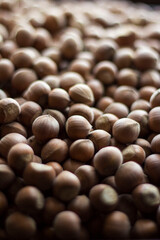 
Lots of brown hazelnuts on a dark background