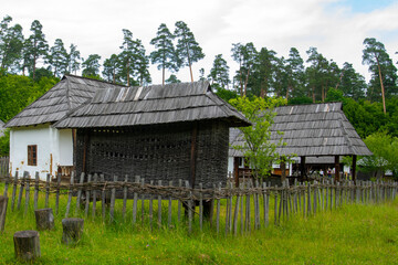 peasant house in the traditional village with thatched roof and tile
