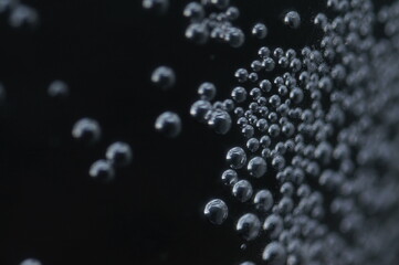 Air bubbles in a dark space with a metallic glow