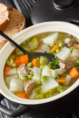Hairst bree is a traditional Scottish hotch potch, a one-pot meal close-up in a pot on the table. Vertical