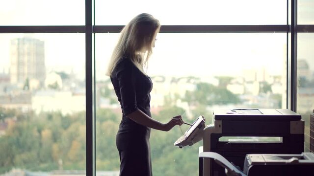Businesswoman Using Printer In Office.Girl Using Copier For Replicate Paperwork.Woman Preparing Financial Audit Report For Marketing Strategy.Secretary Girl Sending Fax On Email And Printing Document