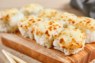 Baked shrimp rolls on wooden board top view