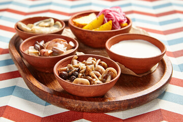 Snack assortment on wooden tray side view