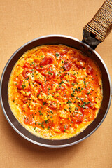 Omelette with tomatoes and seasoning
