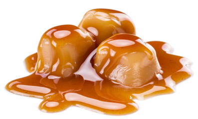Caramel candies covered with melted sugar caramel isolated on white background.