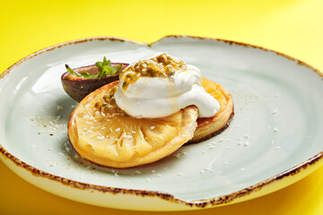 Pineapple slices with maracuya sauce side view