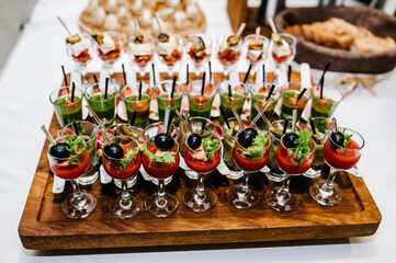 Plate on the table with gourmet variety of mini appetizers with different toppings. Assorted Italian appetizer.