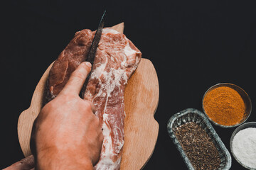 The butcher cuts the pork, marinates the raw meat and cook the kebab.