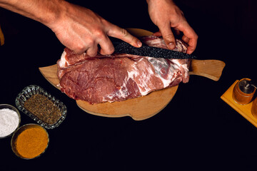 The butcher cuts the pork, marinates the raw meat and cook the kebab.