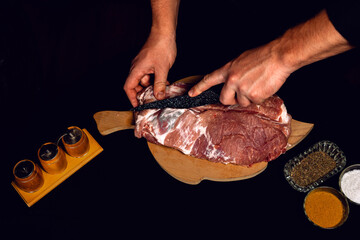 The butcher cuts the pork, marinates the raw meat and cook the kebab.