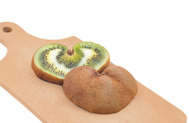 Heart shaped kiwi fruit on wooden board