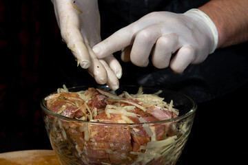 The man marinates the pork, adds the grated potatoes and prepares a tasty and juicy kebab.