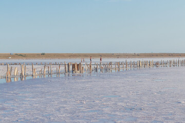 Blue salt lake at the site of an abandoned salt plant at sunset