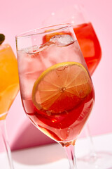 Raspberry spritz cocktail. Pink background