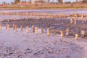 Pink salt lake at the site of an abandoned salt plant at sunset