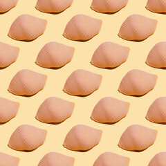 Seamless pattern with konkiloni pasta on yellow background.