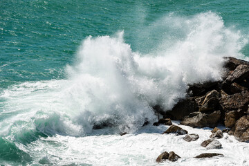 Large white waves of the Sea Break on the Rocks. Breakwater in the Gulf of La Spezia, Liguria, Italy