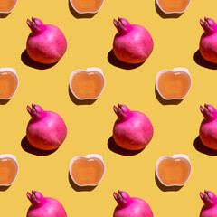 Rosh hashanah. Seamless pattern with pomegranate and honey on yellow background. 