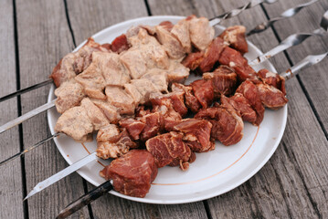 Raw chicken shish kebab with vegetables and spices. Top view. Free space for your text. Rustic style