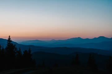 Silhouette of mountains, blue foggy mountains with mist and fog.