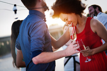 Group of happy friends drinking champagne and celebrating New Year
