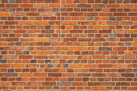 Red brick. Old brick wall, old texture of redstone blocks close up.