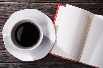 close up cup of black coffee and blank note book
