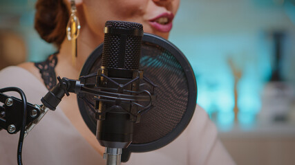 Presenter recording voice in home studio for media using professional microphone. Creative online...