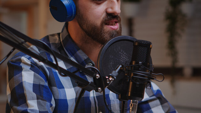 Close up of vlogger holding micophone while speaking during online interview. Creative online show On-air production internet broadcast host streaming live content, recording digital social media