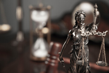 Lawyers office concept. Law symbols composition: Themis sculpture, gavel and scale.