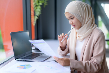 Young muslim hijab business woman in co-working Space.