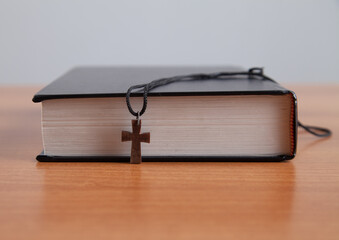 Holy Bible with a wooden cross.