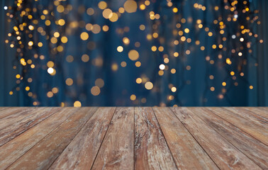 holiday illumination and decoration concept - empty wooden surface or table with christmas golden lights on blue background - Powered by Adobe