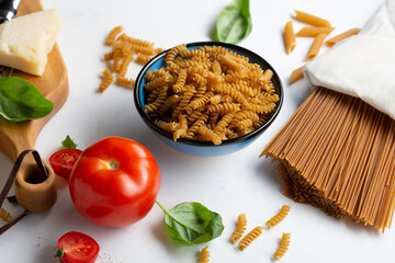 Whole grain pasta on white table