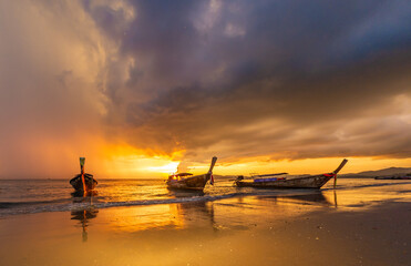 Fototapeta na wymiar Traditional thai boats at sunset beach. Ao Nang Krabi province