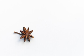 star anise on a white background. this aromatic spice is used for cooking food and various drinks