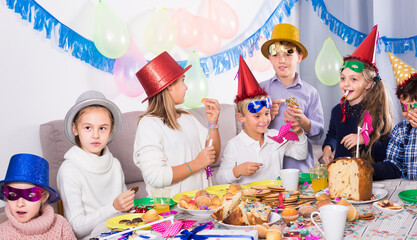 cheerful kids having good time during friend birthday party