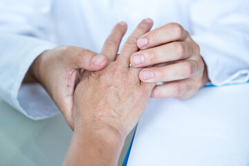 Healthcare - Orthopedist examining patients hand.