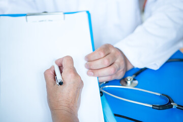 Healthcare - signing a form in hospital or doctor's office.