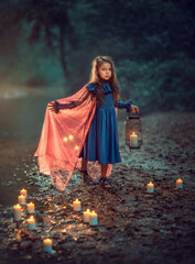 Girl in dress with lantern in a dark forest © Kate BLC