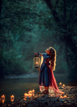 Girl in dress with lantern in a dark forest